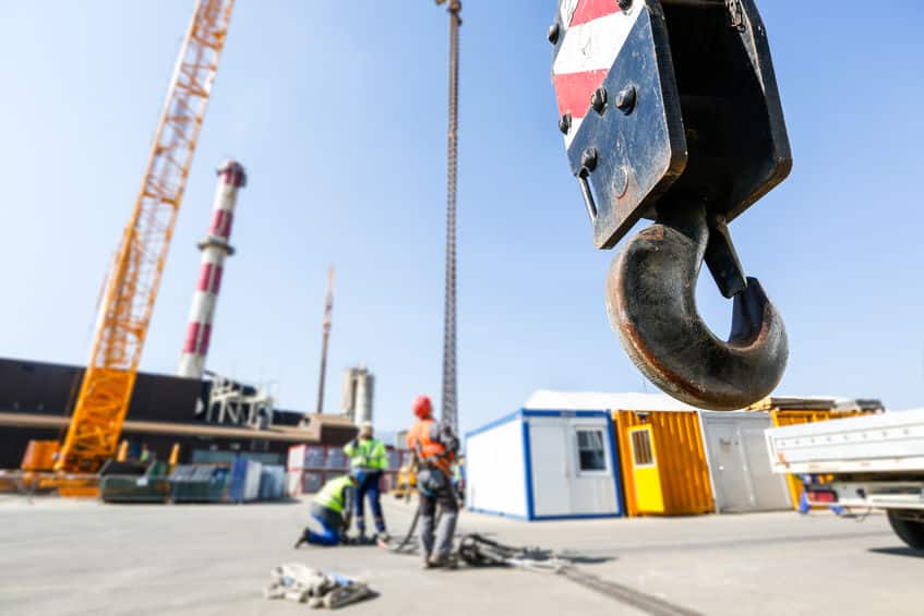 Crane hook with workers in the background