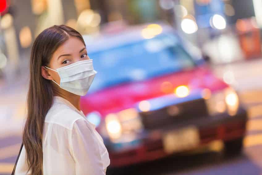 Flu disease virus spreading protection mask protective against influenza viruses and diseases. Asian woman wearing surgical mask on face in public spaces. Healthcare.